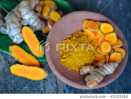 Turmeric roots and powder on  background 45283268