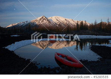 Campsite with orange tent and canoe on a lake Campsite with orange tent and canoe on a lake 45283535