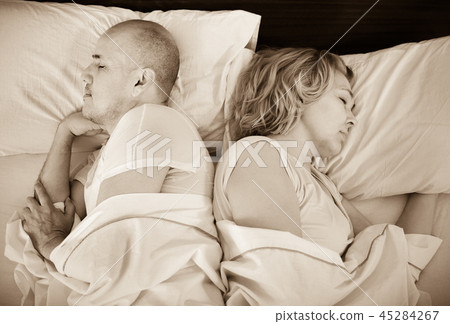 Handsome mature man and woman taking a nap Handsome mature man and woman taking a nap 45284267
