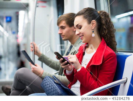 Happy couple reading smartphone and e-book Happy couple reading smartphone and e-book 45284276