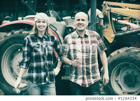 Driver and assistant near harvester 45284334