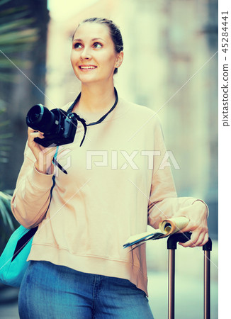 Smiling female is leafing through the booklet Smiling female is leafing through the booklet 45284441