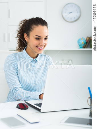 Adult woman working at laptop 45284458