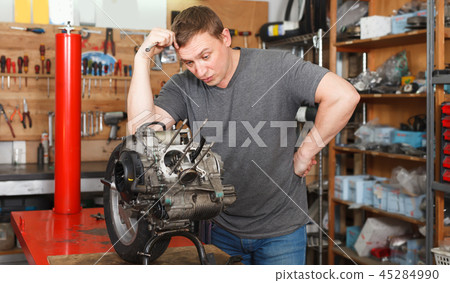 Man is thinking in time repairing detail 45284990