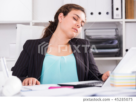 Female trainee is sleeping in office Female trainee is sleeping in office 45285075