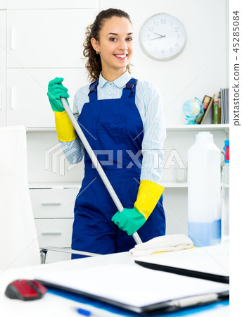 Woman with supplies cleaning in office 45285084