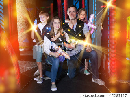 Kids and parents with laser guns in beams Kids and parents with laser guns in beams 45285117