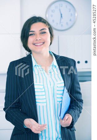 Female office worker is going to meet first visitors Female office worker is going to meet first visitors 45285277