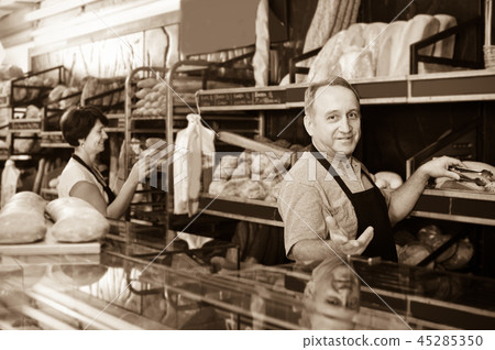 staff offering fresh baguettes staff offering fresh baguettes 45285350