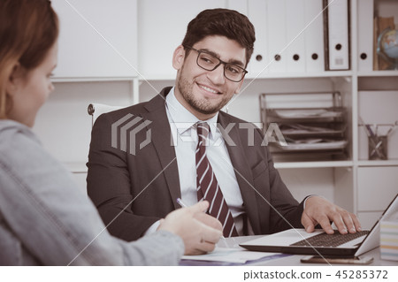 Businessman talking to colleague Businessman talking to colleague 45285372