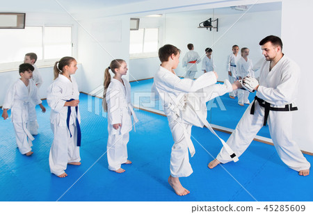 Positive children practicing karate moves 45285609