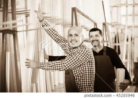 Two PVC industry workers in coveralls . 45285946