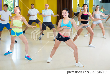 Young group of people are learning zumba movements Young group of people are learning zumba movements 45286053