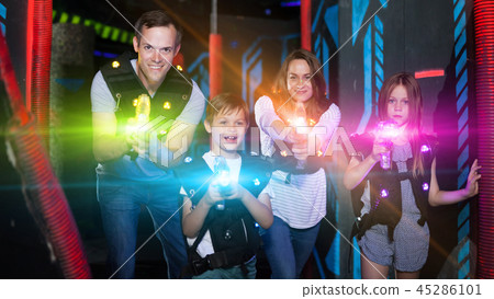 Kids and adults in beams on lasertag arena Kids and adults in beams on lasertag arena 45286101