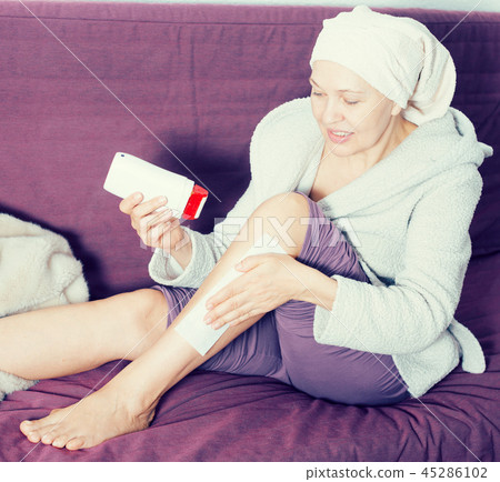 Woman doing body hair removal Woman doing body hair removal 45286102