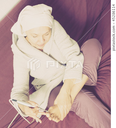 Woman doing pedicure Woman doing pedicure 45286114