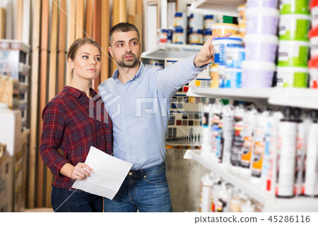 Two designer with shop list looking paint Two designer with shop list looking paint 45286116