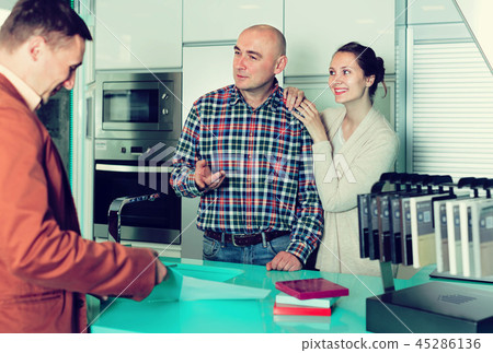 shop assistant working with mature customer in store shop assistant working with mature customer in store 45286136