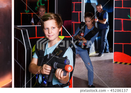 Teen boy playing laser tag Teen boy playing laser tag 45286137