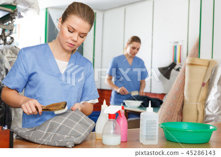 Woman working in dry cleaner Woman working in dry cleaner 45286143