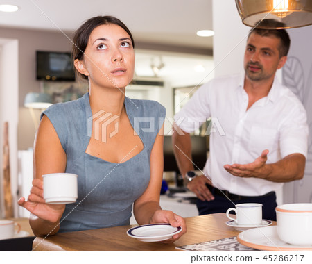 Frustrated girl drinking coffee with angry boyfriend Frustrated girl drinking coffee with angry boyfriend 45286217