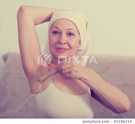 Woman doing body hair removal Woman doing body hair removal 45286254