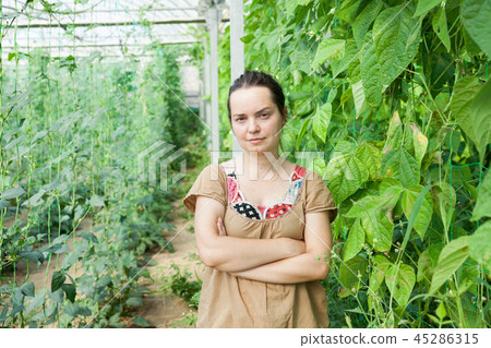 Female farmer in glasshouse Female farmer in glasshouse 45286315