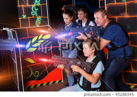 Kids and adults playing lasertag 45286345