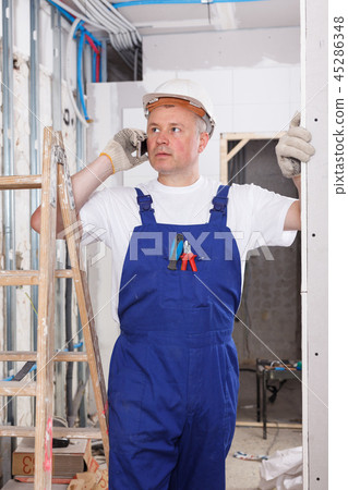 Worker having serious phone conversation Worker having serious phone conversation 45286348