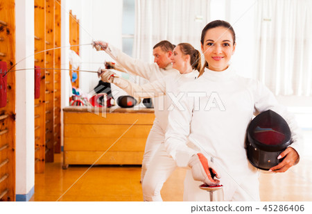 female in uniform standing at fencing room 45286406