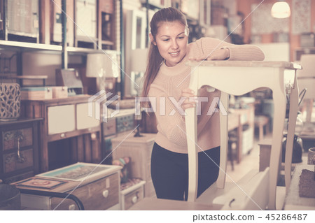 Girl customer touching bedside in the furniture store 45286487