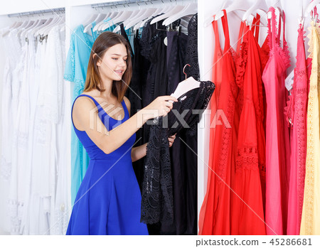 Girl choosing new dress in clothing store 45286681
