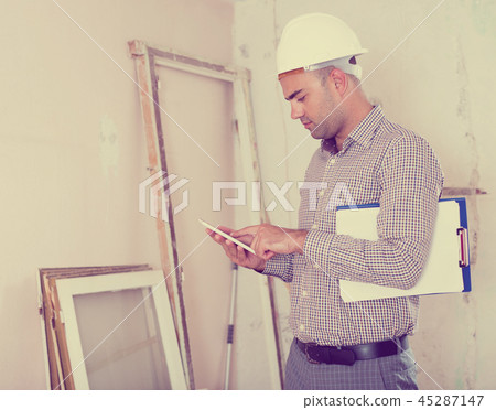 Man engineer talking on the mobile phone Man engineer talking on the mobile phone 45287147