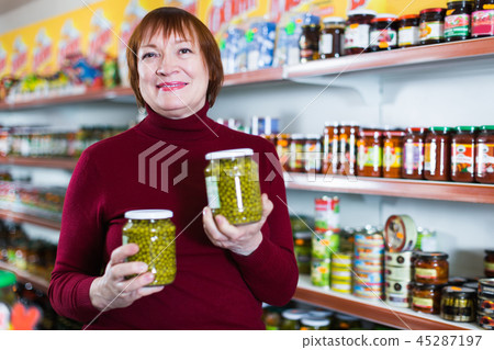 cheerful woman with canned jar of peas cheerful woman with canned jar of peas 45287197