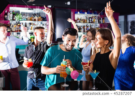 Man with woman are drinking cocktails on corporate party. Man with woman are drinking cocktails on corporate party. 45287207