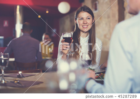 Glad girl with man enjoying meal at restaurant 45287289