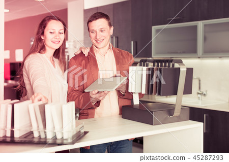 Young couple customers choosing tabletop Young couple customers choosing tabletop 45287293