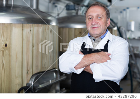 Portrait of brewer who is standing on his workplace 45287296
