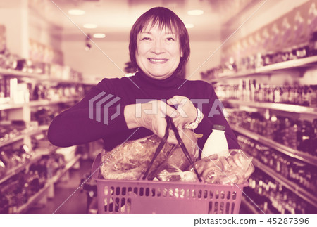 consumer in the supermarket choosing food with basket consumer in the supermarket choosing food with basket 45287396