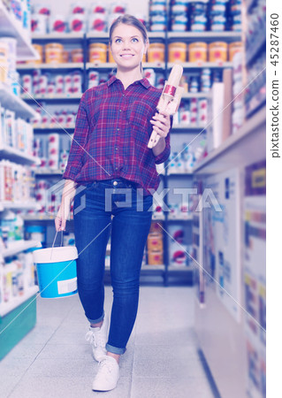 designer is holding paint and brushes for redecorate room designer is holding paint and brushes for redecorate room 45287460