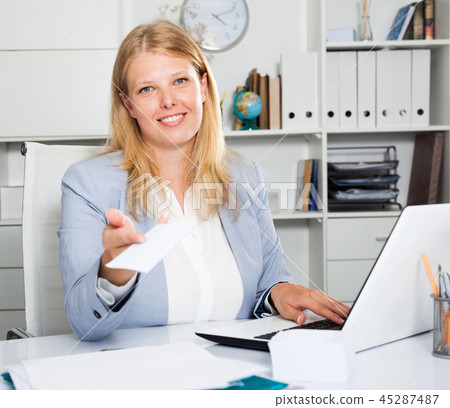Business woman sitting giving white sticker Business woman sitting giving white sticker 45287487