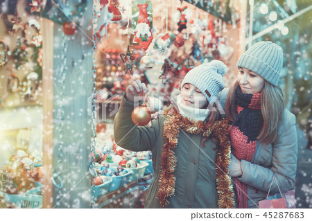 Smiling female and her daughter are choosing decorations for Chr Smiling female and her daughter are choosing decorations for Chr 45287683