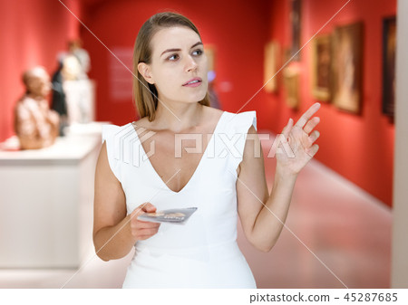 Woman observing museum exposition Woman observing museum exposition 45287685