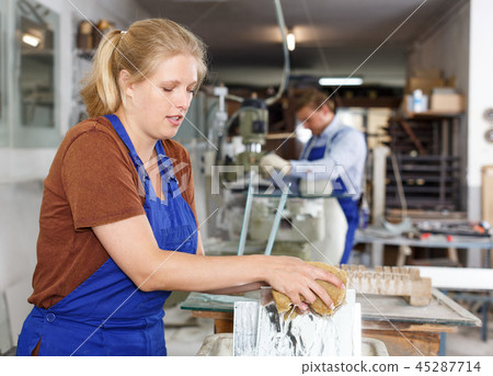 Workwoman cleaning glass 45287714