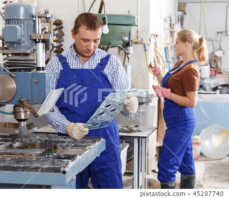 Craftsman working on glass drilling machine 45287740