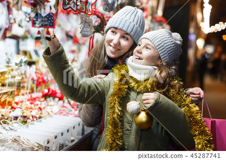 Smiling girl with woman are buying Christmas ornamentals 45287741