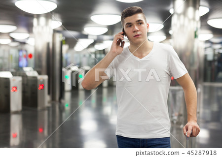 Man traveling on subway and using smartphone 45287918