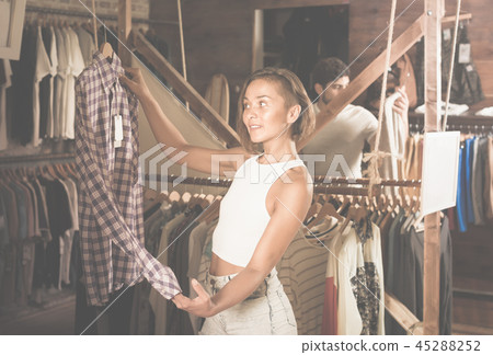 portrait of woman choosing clothers in the modern shop 45288252