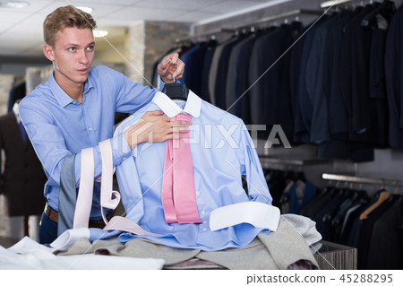 Portrait of man customer choosing tie 45288295