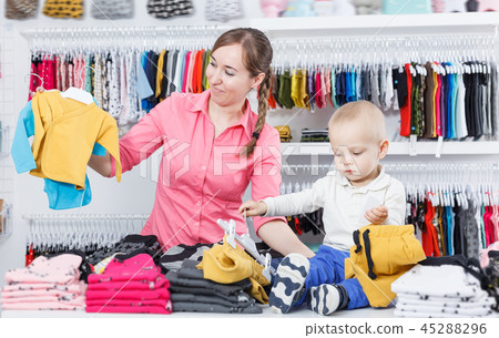 Portrait positive boy with mother in kid store 45288296